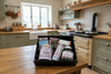 Gift box with various products including a jar of butter fudge on a wooden surface